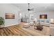 Open concept living room featuring hardwood floors, neutral paint, and modern ceiling fan at 19267 Wildwood Dr, Brooksville, FL 34601
