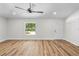 Living room featuring hard surface floors, white walls, bright light, and a white entry door at 19267 Wildwood Dr, Brooksville, FL 34601