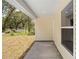This home features a convenient walkway, neutral siding, and outdoor space at 19267 Wildwood Dr, Brooksville, FL 34601