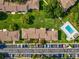 Aerial view of condo with parking, pool, and manicured landscaping at 214 Meadow Ln # 214, Oldsmar, FL 34677