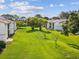 Lawn view of condos featuring mature trees and landscaping at 214 Meadow Ln # 214, Oldsmar, FL 34677
