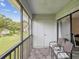 Relaxing balcony with seating and views of the well-maintained lawn and mature trees at 214 Meadow Ln # 214, Oldsmar, FL 34677