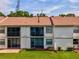 Rear view of condo showcasing patio and well-kept grounds at 214 Meadow Ln # 214, Oldsmar, FL 34677