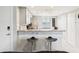 Kitchen bar with granite countertops, modern appliances, seating for two, and pendant lighting at 214 Meadow Ln # 214, Oldsmar, FL 34677