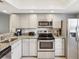 Bright kitchen features stainless steel appliances and granite countertops at 214 Meadow Ln # 214, Oldsmar, FL 34677