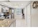 Spacious kitchen with granite countertops, stainless steel appliances, and natural light at 214 Meadow Ln # 214, Oldsmar, FL 34677