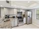 Bright and modern kitchen with stainless steel appliances and granite countertops at 214 Meadow Ln # 214, Oldsmar, FL 34677
