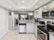 Open-concept kitchen with stainless steel appliances and granite counters at 214 Meadow Ln # 214, Oldsmar, FL 34677