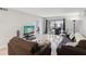 Bright living room with hardwood floors, comfortable seating, and a sliding glass door leading to a balcony at 214 Meadow Ln # 214, Oldsmar, FL 34677