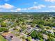 Aerial view of neighborhood, surrounded by lush green trees and clear blue skies at 218 N Bay Hills Blvd, Safety Harbor, FL 34695