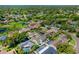 Aerial view of the home showcases the pool, patio, and lush landscaping at 218 N Bay Hills Blvd, Safety Harbor, FL 34695