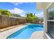 Backyard oasis with in-ground pool, lush landscaping, lounge chairs, and privacy fence at 218 N Bay Hills Blvd, Safety Harbor, FL 34695