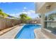 Inviting backyard oasis featuring a sparkling in-ground pool, lush landscaping, and lounge chairs at 218 N Bay Hills Blvd, Safety Harbor, FL 34695