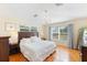 Bright bedroom with hardwood floors, chandelier, and large windows with backyard views at 218 N Bay Hills Blvd, Safety Harbor, FL 34695