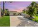 Inviting home featuring a barrel archway and lush tropical landscaping creating a serene and picturesque setting at 218 N Bay Hills Blvd, Safety Harbor, FL 34695