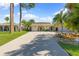 Inviting home featuring a barrel archway, lush tropical landscaping, and a long driveway at 218 N Bay Hills Blvd, Safety Harbor, FL 34695