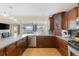 Stylish kitchen featuring stainless steel appliances, wood cabinets, and a breakfast bar, perfect for entertaining at 218 N Bay Hills Blvd, Safety Harbor, FL 34695
