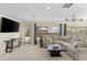 Cozy living room features comfortable seating, a TV, and large windows offering views of the backyard at 218 N Bay Hills Blvd, Safety Harbor, FL 34695