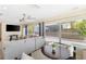Bright living room with comfortable seating, a ceiling fan, and large windows providing ample natural light and backyard views at 218 N Bay Hills Blvd, Safety Harbor, FL 34695