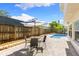 Back patio features a table and chairs, along with shade from the patio umbrella at 218 N Bay Hills Blvd, Safety Harbor, FL 34695
