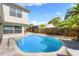 Refreshing pool and brick patio, perfect for outdoor lounging near tropical landscaping at 218 N Bay Hills Blvd, Safety Harbor, FL 34695