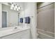 Well-lit bathroom featuring a clean white sink, a large mirror, and access to a bathtub at 2404 W Jetton Ave, Tampa, FL 33629