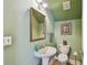 This bathroom has green walls, a mirror and a toilet at 2404 W Jetton Ave, Tampa, FL 33629