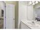 Bright bathroom sink with a tile countertop, mirror, and access to a bedroom at 2404 W Jetton Ave, Tampa, FL 33629