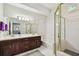 Bathroom featuring dual sinks, a shower, and a tub with white tile and neutral decor at 2404 W Jetton Ave, Tampa, FL 33629