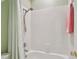 Clean bathroom with a shower featuring white tiles and a convenient shower head with curtain at 2404 W Jetton Ave, Tampa, FL 33629