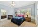 Cozy bedroom featuring a sitting area and three bright windows with plantation shutters at 2404 W Jetton Ave, Tampa, FL 33629