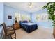 Bedroom with light blue walls, neutral carpet, two windows with shutters and an accent chair at 2404 W Jetton Ave, Tampa, FL 33629