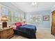 Inviting bedroom with three windows and shutters, offering natural light and carpeted floors at 2404 W Jetton Ave, Tampa, FL 33629