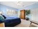 Bedroom with light blue walls, neutral carpet, one window with shutters, a wardrobe, and indoor tree at 2404 W Jetton Ave, Tampa, FL 33629