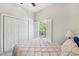 Cozy bedroom with neutral carpet, shuttered window with a view, and double door closet at 2404 W Jetton Ave, Tampa, FL 33629