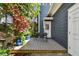 Inviting deck with outdoor seating and colorful potted plants near the home entrance at 2404 W Jetton Ave, Tampa, FL 33629