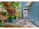Outdoor seating area on deck with potted plants, greenery, and a private backyard at 2404 W Jetton Ave, Tampa, FL 33629
