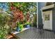 Inviting deck with outdoor seating and colorful potted plants near the home entrance at 2404 W Jetton Ave, Tampa, FL 33629