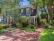 Charming two-story home with manicured lawn, brick pathway, and gated entrance at 2404 W Jetton Ave, Tampa, FL 33629