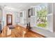 Elegant foyer with hardwood floors, plantation shutters, and views of landscaped outdoors at 2404 W Jetton Ave, Tampa, FL 33629