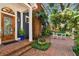 Beautiful home featuring a brick walkway, manicured garden, and charming outdoor seating area at 2404 W Jetton Ave, Tampa, FL 33629