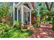 Charming home featuring a brick pathway to the front door with lush, verdant landscaping at 2404 W Jetton Ave, Tampa, FL 33629
