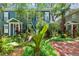 Charming blue two-story home with brick walkway, lush landscaping and a welcoming front door at 2404 W Jetton Ave, Tampa, FL 33629