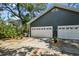 Exterior of home with two-car garage, lush landscaping, and paved driveway at 2404 W Jetton Ave, Tampa, FL 33629