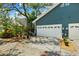 Home with side entry garage, surrounding landscape, and well-maintained driveway at 2404 W Jetton Ave, Tampa, FL 33629