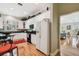 Spacious kitchen featuring white cabinets, modern appliances, hardwood floors, and an eat-in area at 2404 W Jetton Ave, Tampa, FL 33629