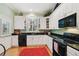 Well-lit kitchen with modern appliances, black countertops, and an eat in area at 2404 W Jetton Ave, Tampa, FL 33629