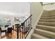 Cozy living room with hardwood floors, a fireplace, and comfortable seating, seen from the staircase at 2404 W Jetton Ave, Tampa, FL 33629