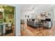 Open-concept living area with hardwood floors, and adjacent powder room at 2404 W Jetton Ave, Tampa, FL 33629