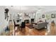 Open-concept living area with hardwood floors, fireplace, and ample seating at 2404 W Jetton Ave, Tampa, FL 33629